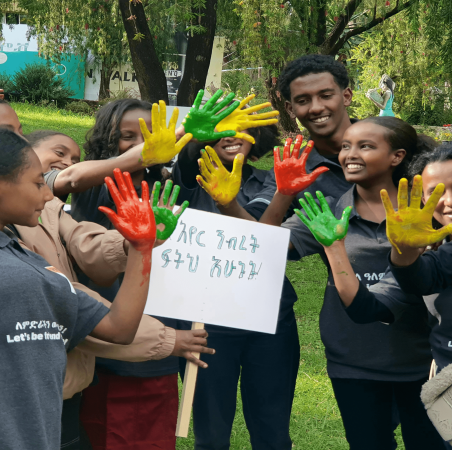 Young people at Global Platforms campaigning through art and holding out a message